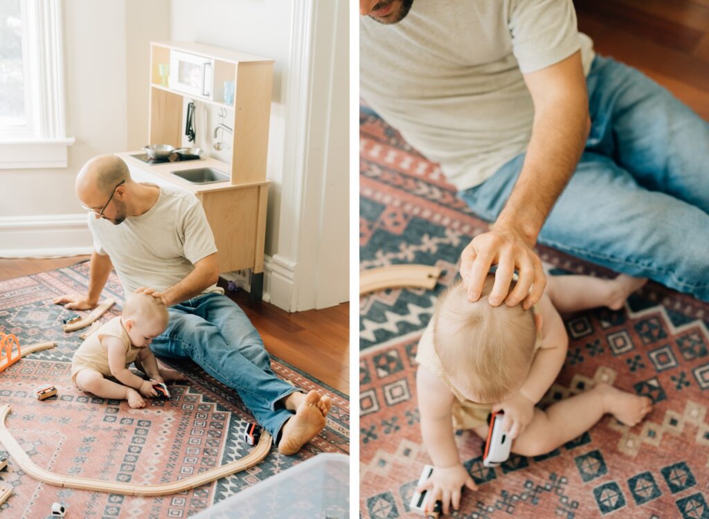 A dad gently caresses his baby's head.